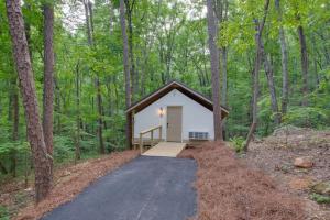 a small cabin in the middle of the woods at 7 Fishing Lure Luxury Glamping Tent Fishing Theme in Scottsboro