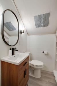 a bathroom with a sink and a toilet and a mirror at 7 Fishing Lure Luxury Glamping Tent Fishing Theme in Scottsboro