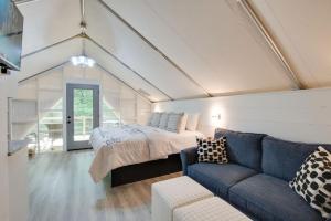 a bedroom with a bed and a couch at 12 Launch Pad Luxury Glamping Tent Space Theme in Scottsboro