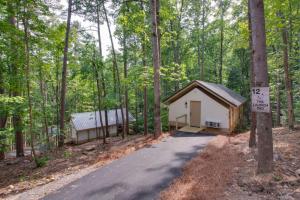 a small house in the middle of the woods at 12 Launch Pad Luxury Glamping Tent Space Theme in Scottsboro