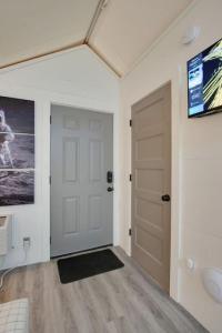 a room with a white door and a television at 12 Launch Pad Luxury Glamping Tent Space Theme in Scottsboro