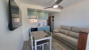 a living room with a couch and a table at Luna Almerimar Golf in Almerimar +28 photos