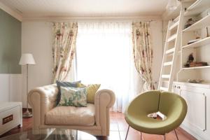a living room with a chair and a window at CASA DA PIA - Pia do Urso in Casais de São Mamede +37 photos