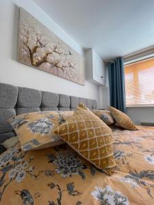 a bedroom with a bed with pillows on it at Chestnut Cottage in East Bergholt