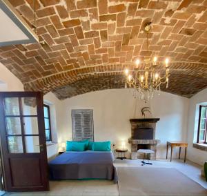 a bedroom with a bed and a chandelier at La Dimora delle Viole in Lauriano