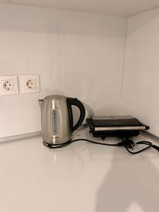 a tea kettle and a toaster sitting on a counter at Odysseas apartments in Agathonisi