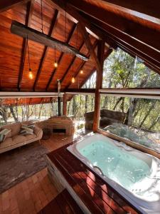 a large room with a hot tub in a house at Recanto das Cachoeiras in Angelina