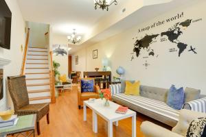a living room with a couch and a world map on the wall at Downtown Baltimore Vacation Rental WFH Friendly! in Baltimore