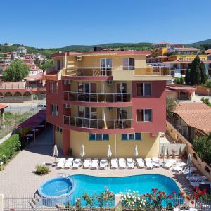 a building with a swimming pool and a resort at Sunny Flower Family Hotel in Sunny Beach