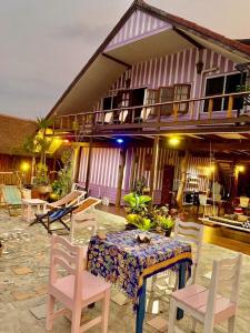 a table and chairs in front of a house at Good View by Koi, Koh Chang in Ko Chang