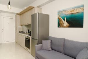 a living room with a couch and a kitchen at EDEL Luxury Apartments in Chania Town