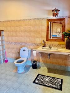 a bathroom with a toilet and a sink and a mirror at Good View by Koi, Koh Chang in Ko Chang