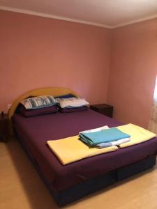 a bedroom with a bed with towels on it at Apartman Perper 2 Trebinje in Trebinje