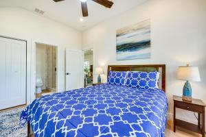 a bedroom with a blue bed and a bathroom at St Augustine Vacation Rental Close to Downtown! in Saint Augustine