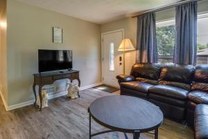 a living room with a leather couch and a table at Pet-Friendly Rex Vacation Rental 18 Mi to Atlanta in Rex