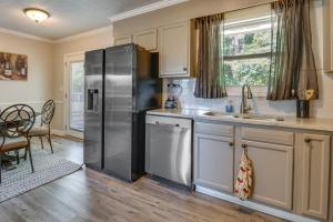 a kitchen with a stainless steel refrigerator and a table at Pet-Friendly Rex Vacation Rental 18 Mi to Atlanta in Rex