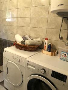 a washing machine with a basket on top of it at Apartman Perper 2 Trebinje in Trebinje