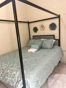 a bedroom with a bed with a metal frame at Cozy 2 bedroom Home 10 min from Airport in San Luis