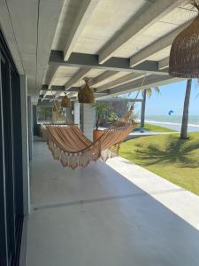 a hammock on the porch of a house at Club de Mar Condo Hotel in Icaraí