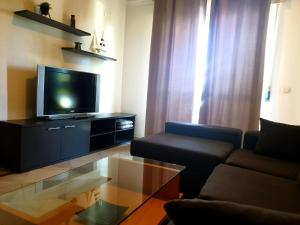 a living room with a couch and a flat screen tv at Apartamento playa - Puerto Banus in Marbella