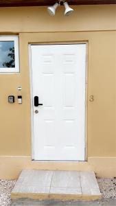 a white door on the side of a house at Luxury one bed room apartment in Nassau