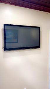 a flat screen tv hanging on a wall at Luxury one bed room apartment in Nassau
