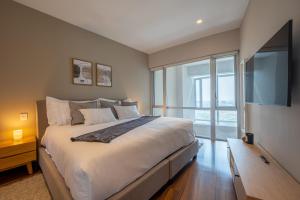 Säng eller sängar i ett rum på Capitalia - Apartments - Reforma Centro