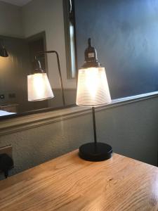 a table with two lights on top of it at The Horse and Farrier Inn and The Salutation Inn Threlkeld Keswick in Threlkeld