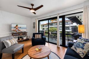 un soggiorno con divano, sedie e tavolo di Casa de Emdeko 202 a Kailua-Kona
