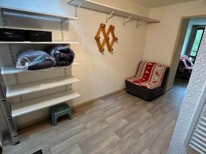 a room with white shelves and a chair and a floor at Studio cosy au pied des pistes avec balcon, proche centre et piscine, navette gratuite - FR-1-515-172 in Villard-de-Lans