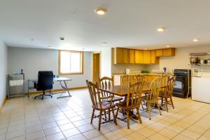 a kitchen and dining room with a table and chairs at Unique Lawrence Escape with WFH-Friendly Workspace 