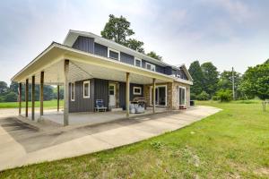 a house with a large driveway in a field at Unique Lawrence Escape with WFH-Friendly Workspace 