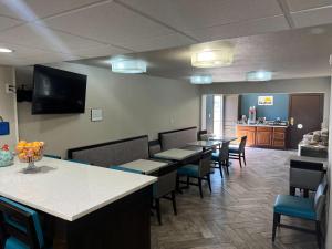 a waiting room with tables and chairs and a kitchen at Days Inn by Wyndham Dalhart in Dalhart