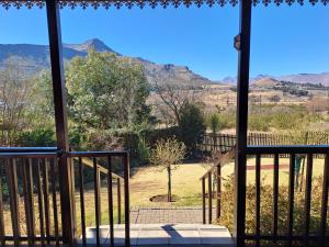 a view of the mountains from the porch of a house at Mystic Mountain Cottage in Clarens
