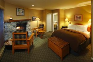 a hotel room with a bed and a fireplace at Emerald Lake Lodge in Field +37 photos