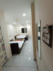 a room with two beds and a hallway at Hotel shipra suites in Ujjain