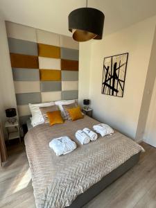 a bedroom with a bed with three towels on it at Apartament Koliber Spa in Rzeszów