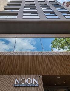 a building with a noon sign on the top of it at Noon Vila Madalena in Sao Paulo