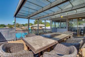 a wooden table and chairs on a deck at Yakima Home Rental Seasonal Outdoor Pool, Hot Tub in Yakima