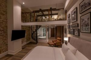 a living room with a bed and a staircase at Hotel La Compania, In The Unbound Collection By Hyatt in Panama City