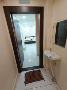 a bathroom with a shower and a sink and a mirror at Hotel shipra suites in Ujjain