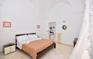 Un dormitorio con una cama en una habitación blanca. en Casa Tosally, en Ostuni