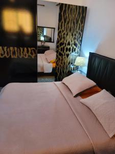 a bedroom with a large bed and a mirror at Unik Private Villa Center in Velipojë