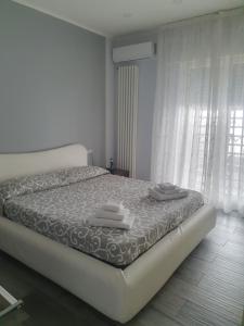 a bedroom with a bed with towels on it at Villa Giulia in Pozzuoli