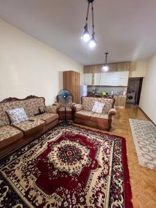 a living room with a couch and a rug at Unik Private Villa Center in Velipojë