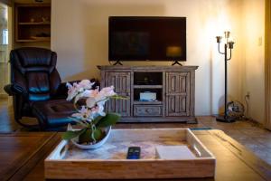 a living room with a television and a coffee table at Desert Mermaid in Sedona in Sedona