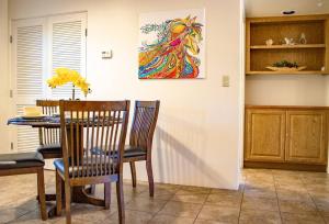 a dining room with a table and chairs and a painting at Desert Mermaid in Sedona in Sedona