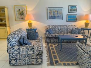 a living room with two couches and a table at Sea Front Villa Direct Access to Crystal Blue Sea Al Alamein, Egypt in El Alamein