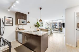 a kitchen with a sink and a counter at Heart of Downtown 1 bd - Pool, Gym, Parking, Office, AC in Vancouver