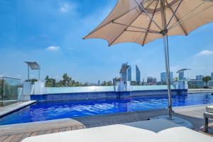 an umbrella sitting next to a swimming pool at 2floors luxury apartment condesa in Mexico City
